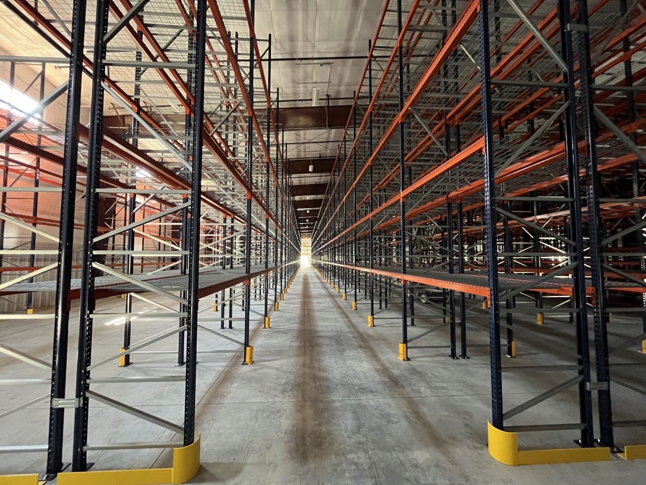 Long selective rack rows with hand-stack pick levels and post protection